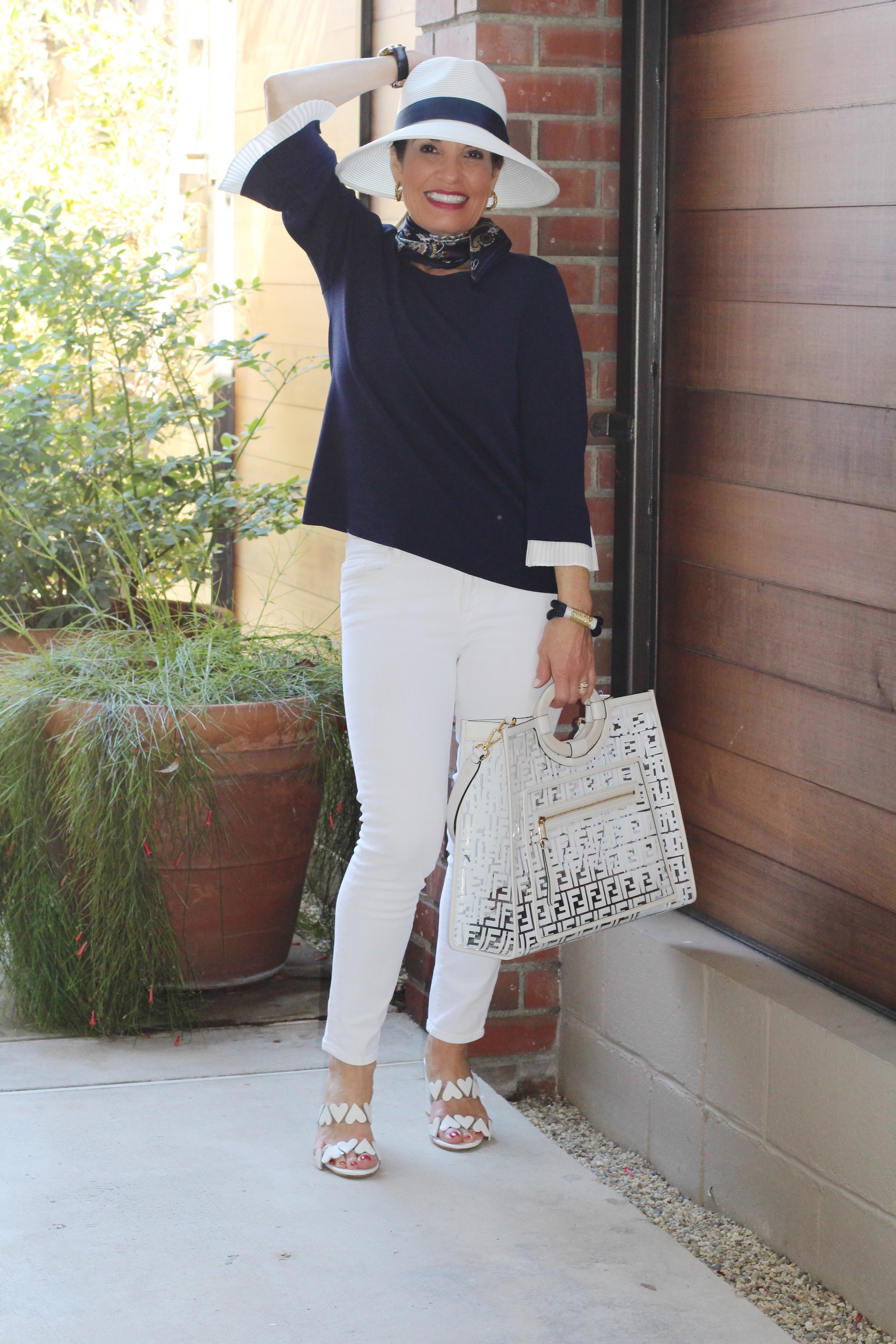 Gottex Hat, Gucci Shades, A World Curated Top and Scarf, (in photos below), J Brand Jeans, Laurence Decade Sandals, Fendi Bag, J Crew Bracelet, Earrings ($10.00) available at Jami Lynn Boutique.