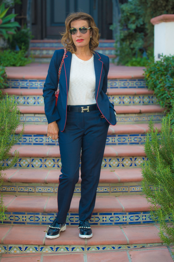 Sandro Pants and Jacket; Rag and Bone T-Shirt; Robert Clergerie Shoes; Hermes Belt; Chanel Handbag, Cuff, and Sunglasses; Christian Dior Earrings.