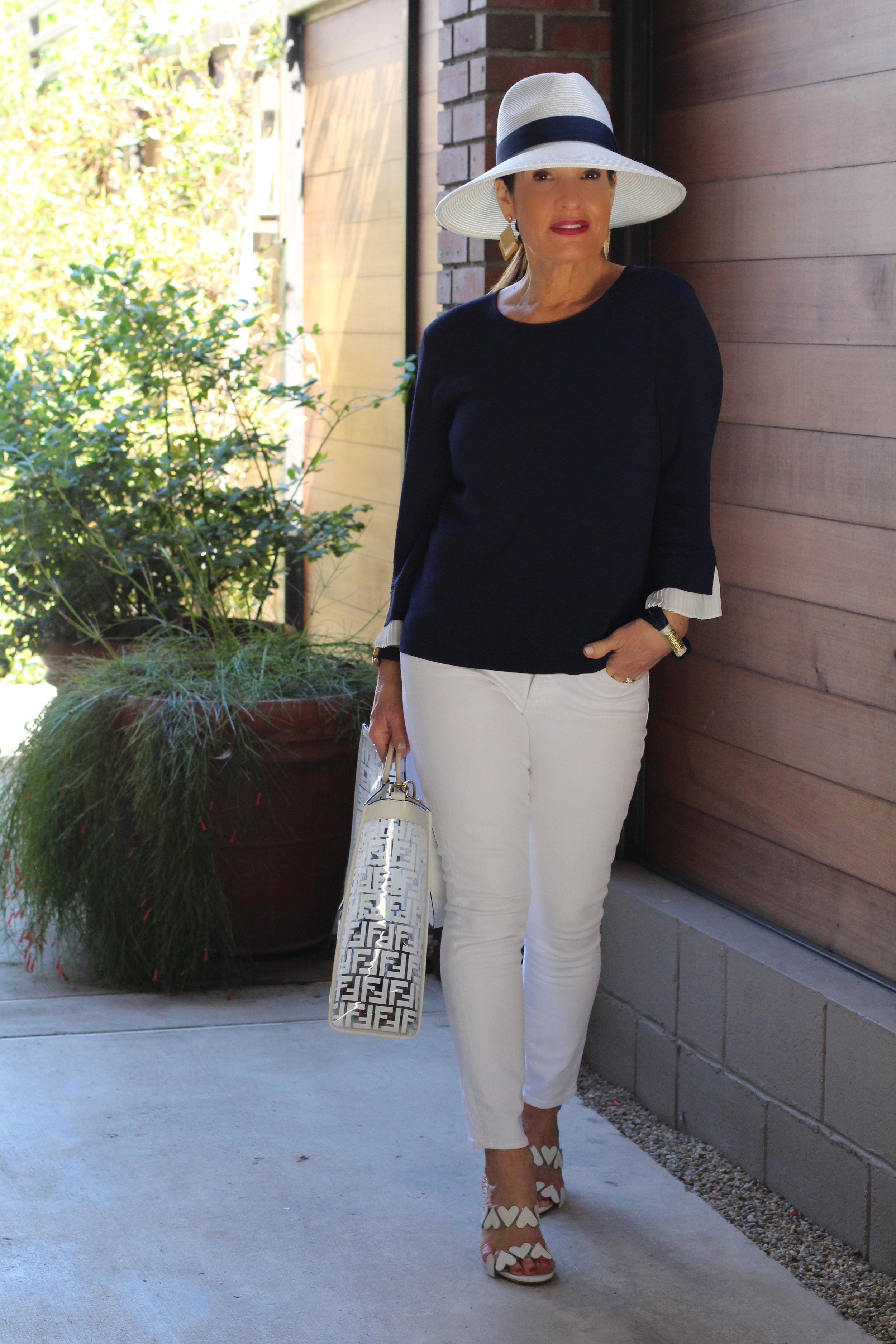 Gottex Hat, Gucci Shades, A World Curated Top and Scarf, (in photos below), J Brand Jeans, Laurence Decade Sandals, Fendi Bag, J Crew Bracelet, Earrings ($10.00) available at Jami Lynn Boutique.