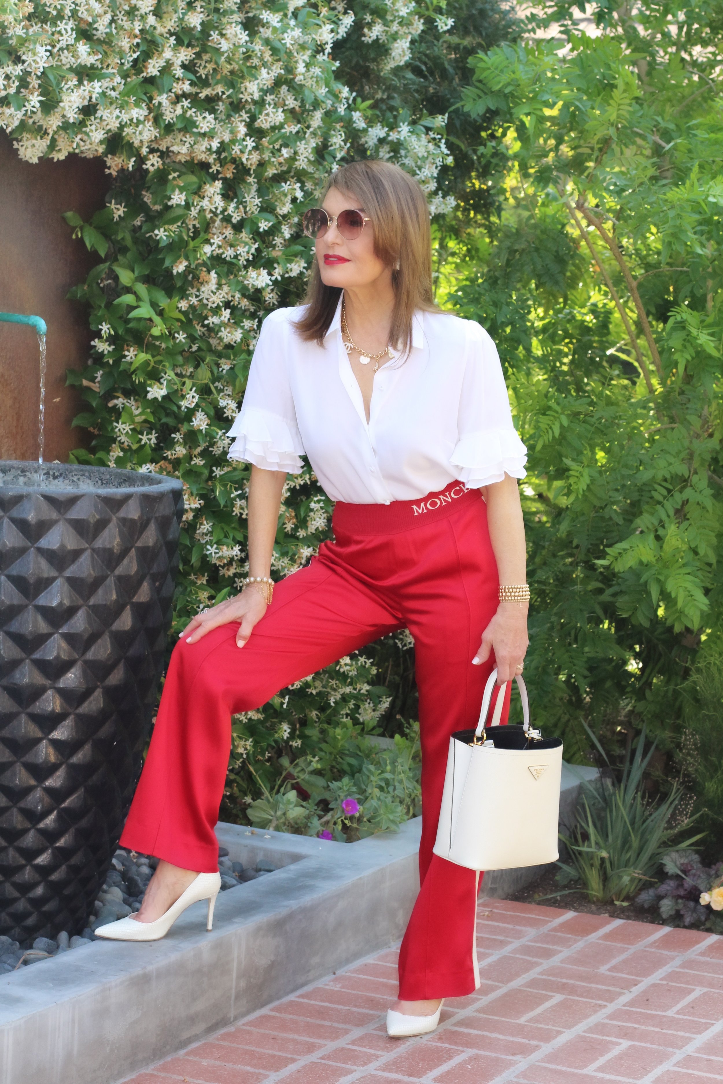 Frame Blouse, Moncler Pants, Giuseppi Zanotti Shoes, Prada Handbag, Jewels by Molly Stretch Beaded Bracelets (left wrist), Anne Sisteron Pearl Stretch Bracelet (right wrist), Cathryn Wagner Necklace, Gucci Sunglasses, By Terry Red Carpet #9 Lip Color.