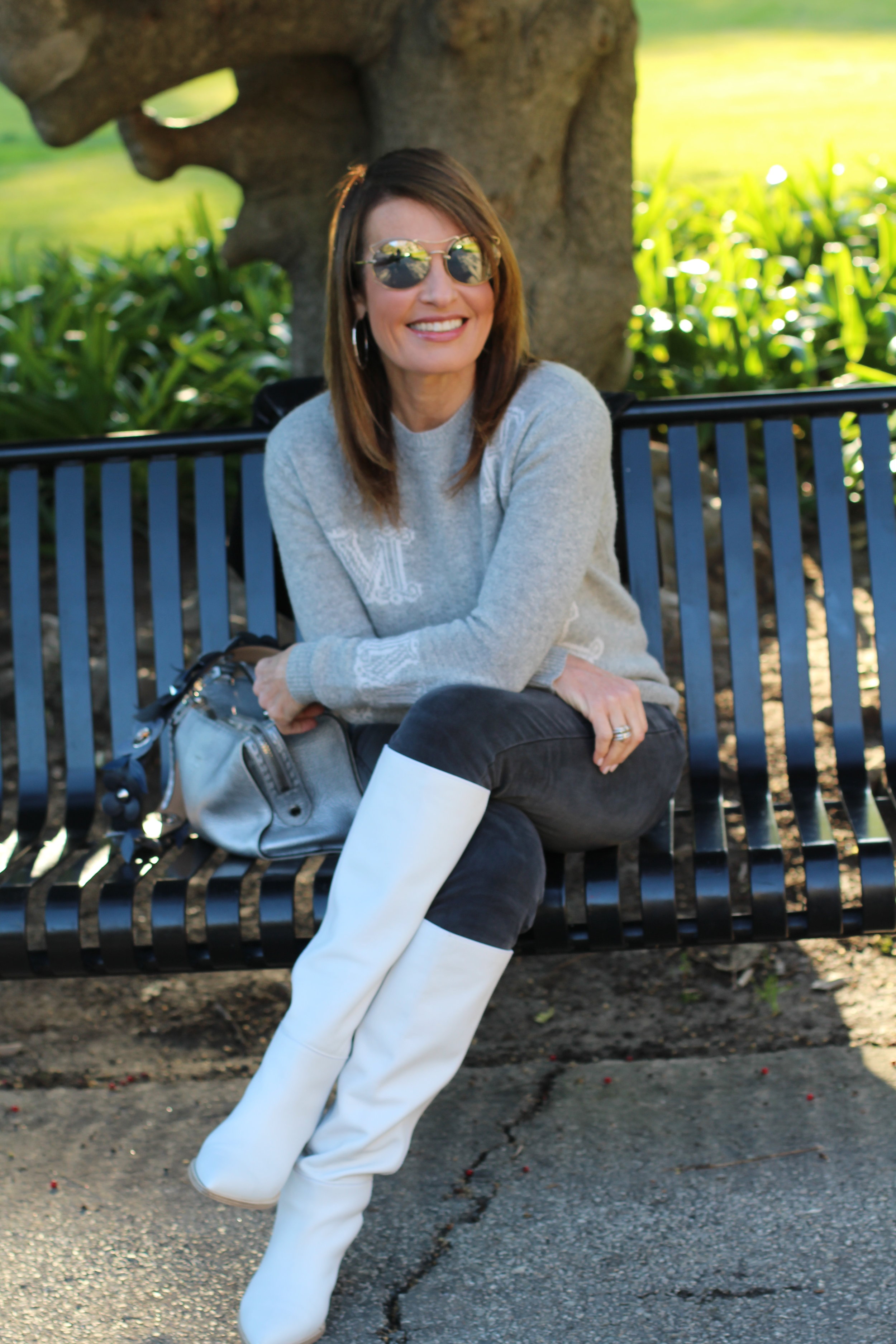 Max Mara Sweater, J Brand Jeans, Gianvito Rossi Boots, Brunello Cucinelli Jacket, Fendi Handbag and Strap, Miu Miu Sunnies, John Hardy Earrings, Spinelli Kilcollin Ring.